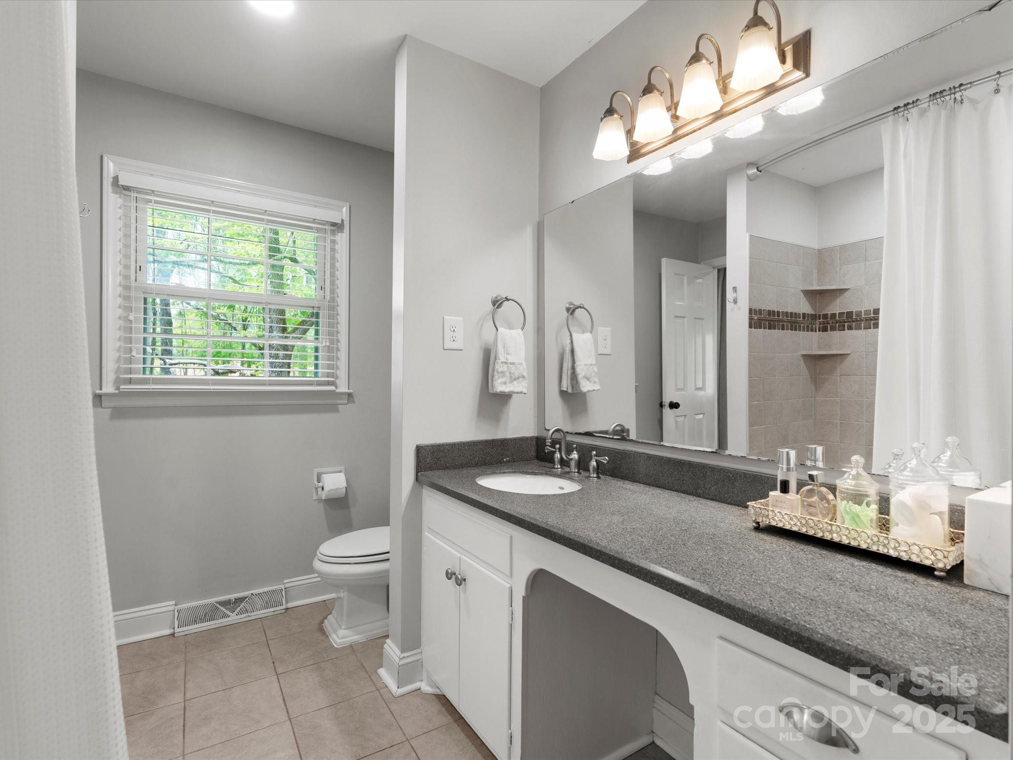 1102 Oak Hill Drive Monroe, NC 28112 - Photo 27 of 33 a bathroom with a granite countertop double vanity sink a toilet and a mirror