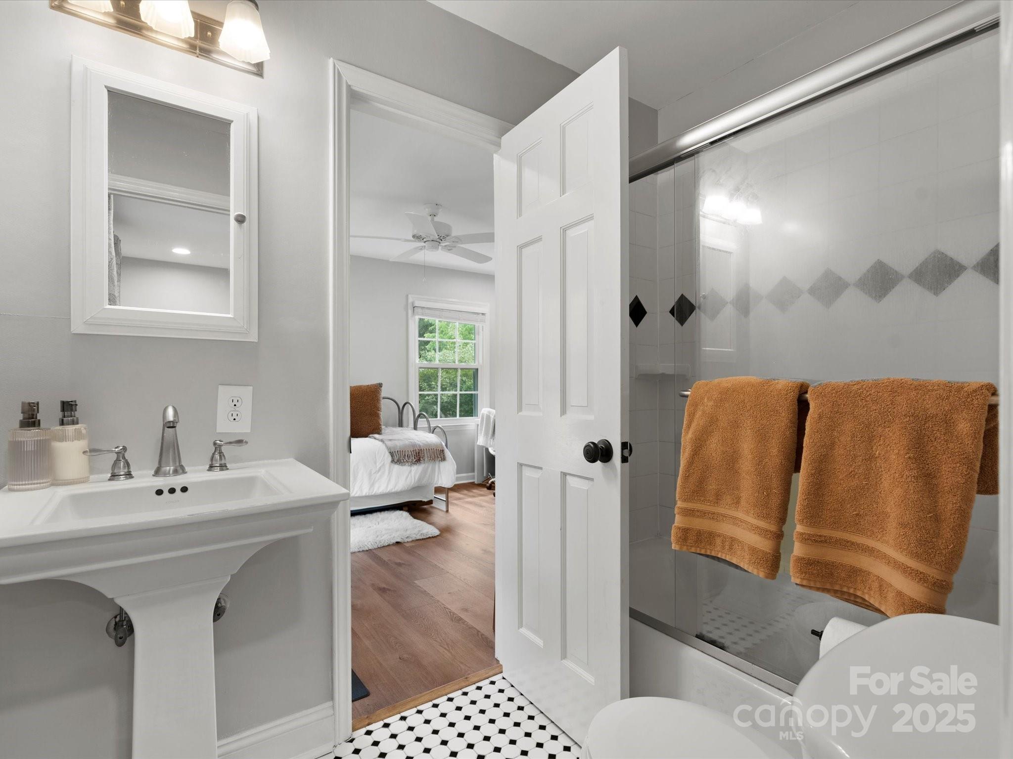 1102 Oak Hill Drive Monroe, NC 28112 - Photo 28 of 33 a en suite bathroom with a double vanity sink a mirror and a shower