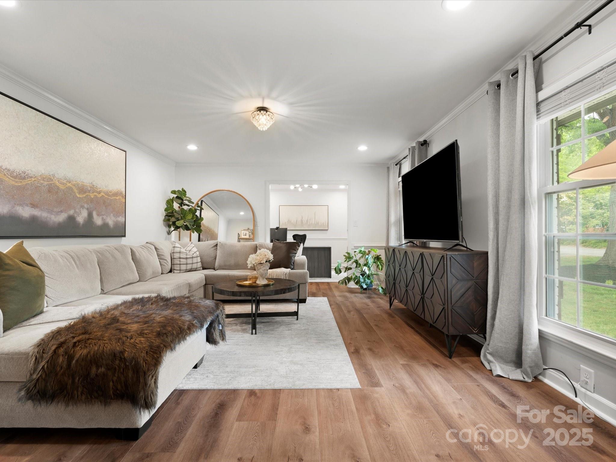 1102 Oak Hill Drive Monroe, NC 28112 - Photo 6 of 33 a living room with furniture and a flat screen tv