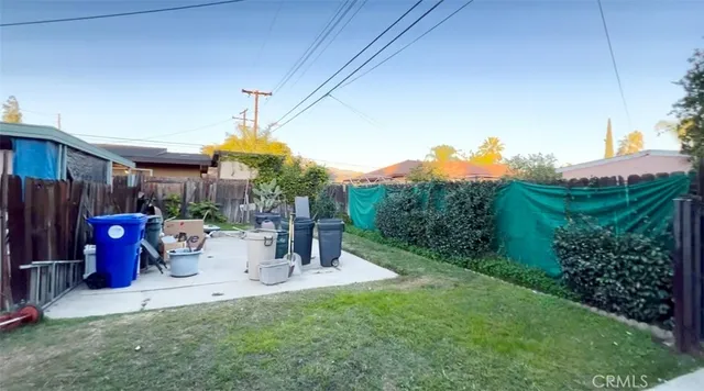 a view of two chairs and table in patio