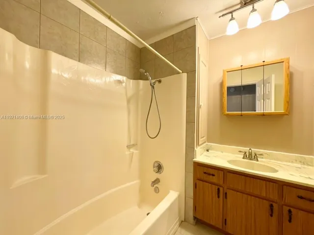 a bathroom with a shower and a sink