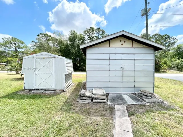 a backyard of a house with table and chairs
