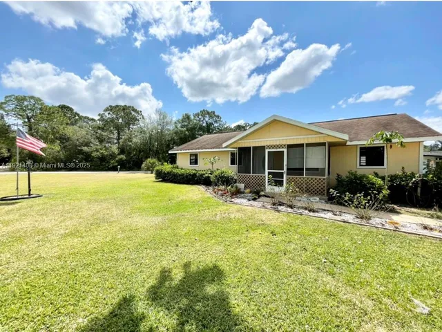 a front view of a house with swimming pool having outdoor seating