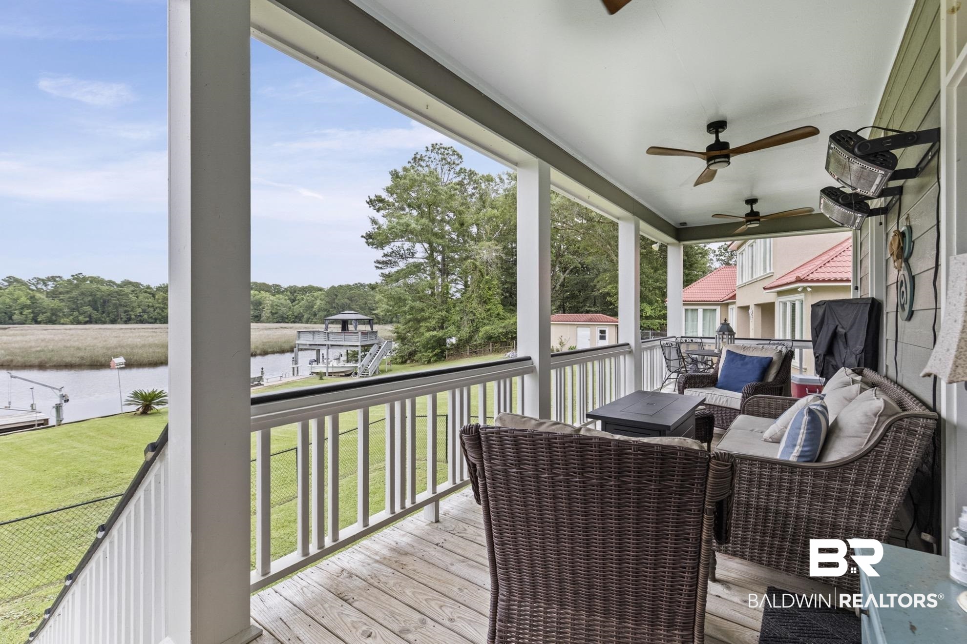 12171 Marguerite Drive Coden, AL 36523 - Photo 20 of 44 Covered porch with wood-finish flooring and multiple ceiling fans