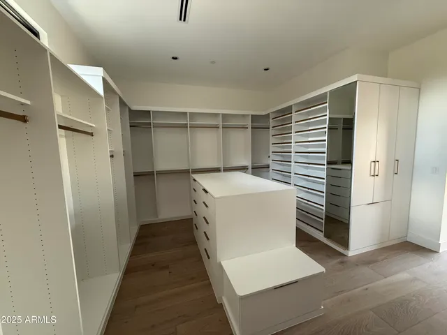 a view of a dry yard with trees