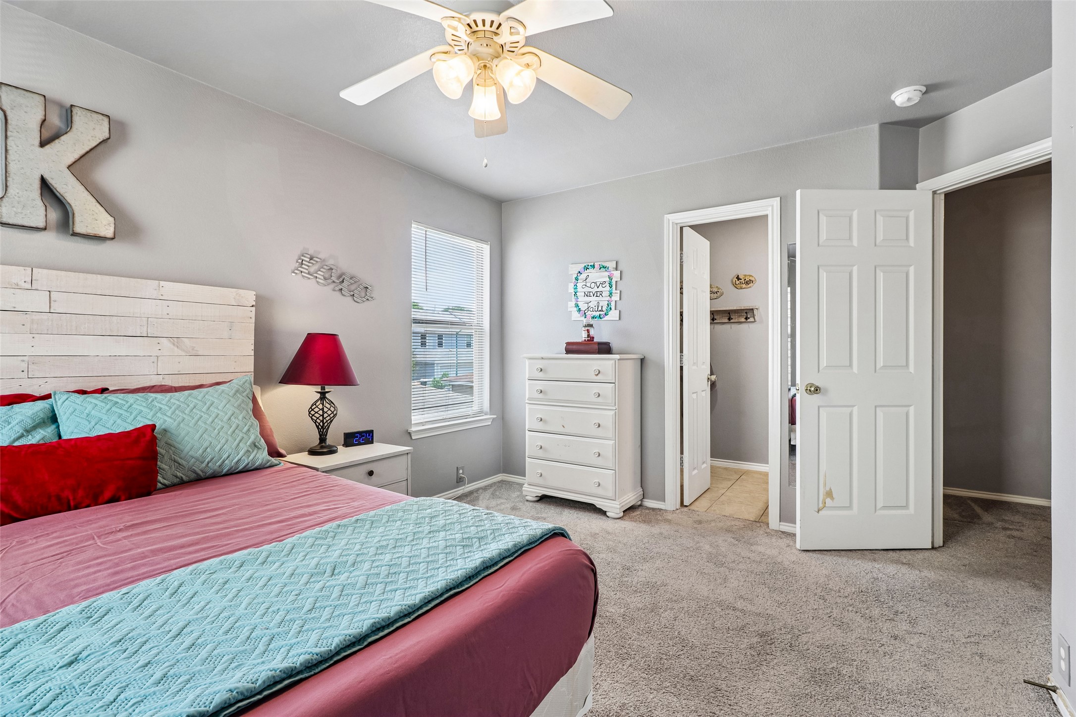 311 A Utterback Kyle, TX 78640 - Photo 17 of 40 a bedroom with a bed and a chandelier