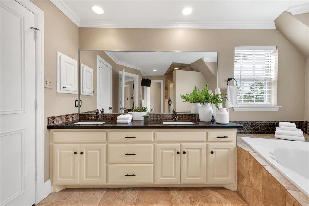 5102 Ridgedale Avenue Dallas, TX 75206 - Photo 17 of 27 Bathroom vanity featuring dual under-mount sinks, a black countertop, and a large wall-mounted mirror