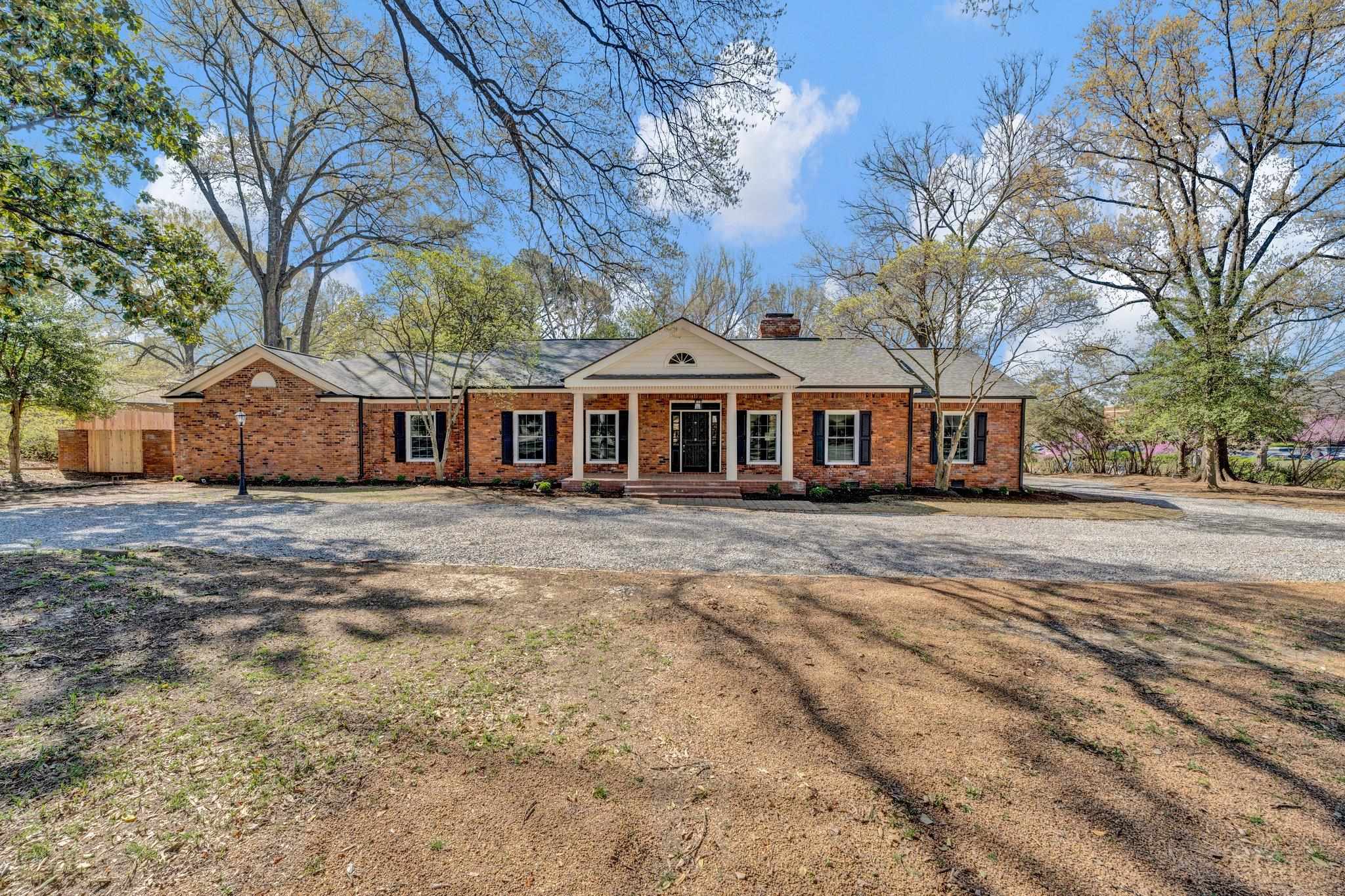 a front view of a house with a garden