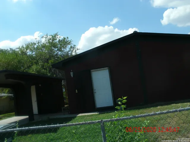 a backyard of a house with lots of green space and plants