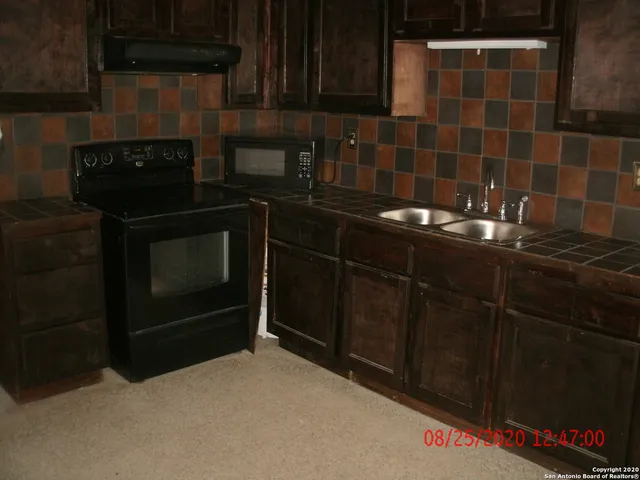 a kitchen with a sink and cabinets