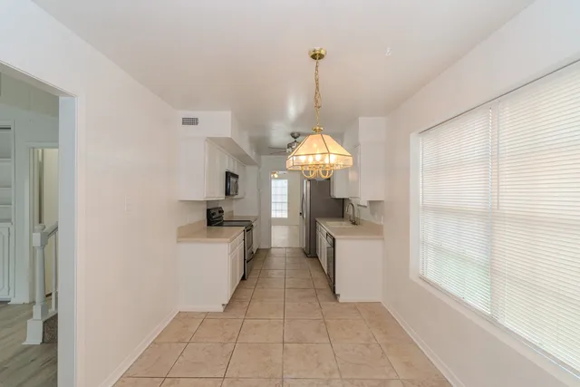 a kitchen with a sink a stove and refrigerator