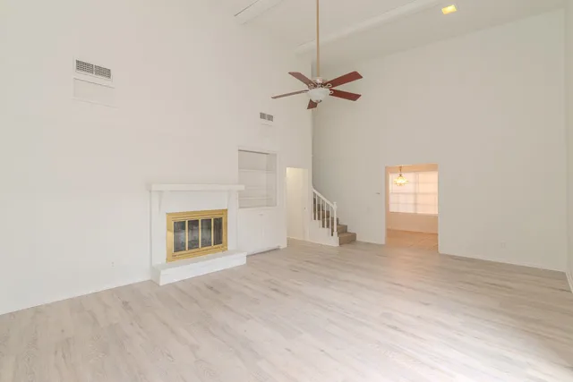 a view of empty room with a fireplace