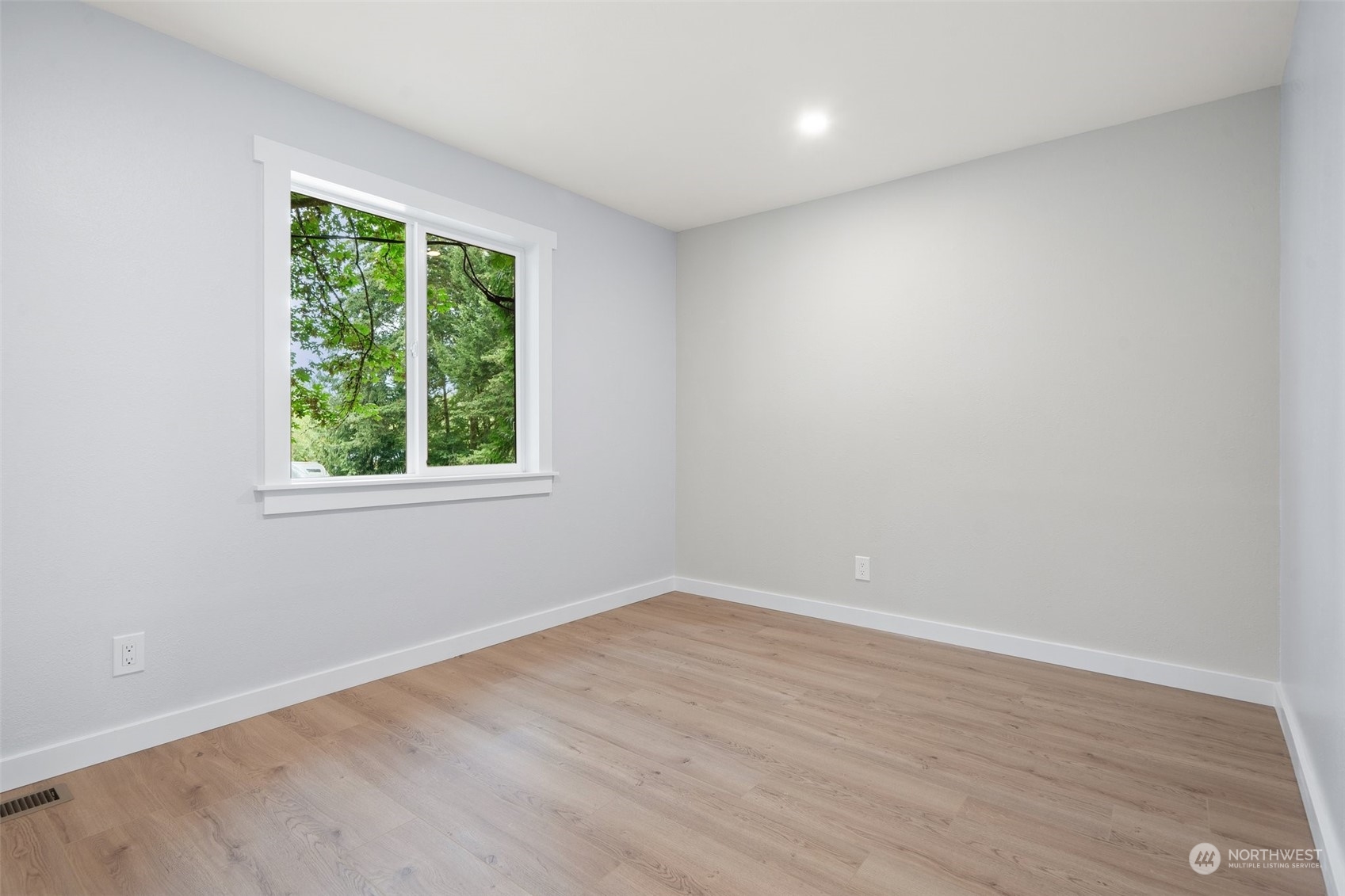 18832 196th Avenue Southeast Renton, WA 98058 - Photo 17 of 33 an empty room with wooden floor and windows