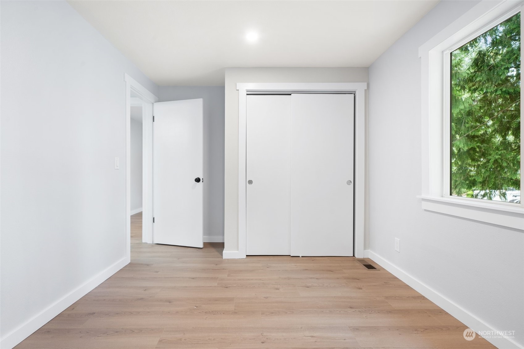 18832 196th Avenue Southeast Renton, WA 98058 - Photo 18 of 33 an empty room with wooden floor and windows