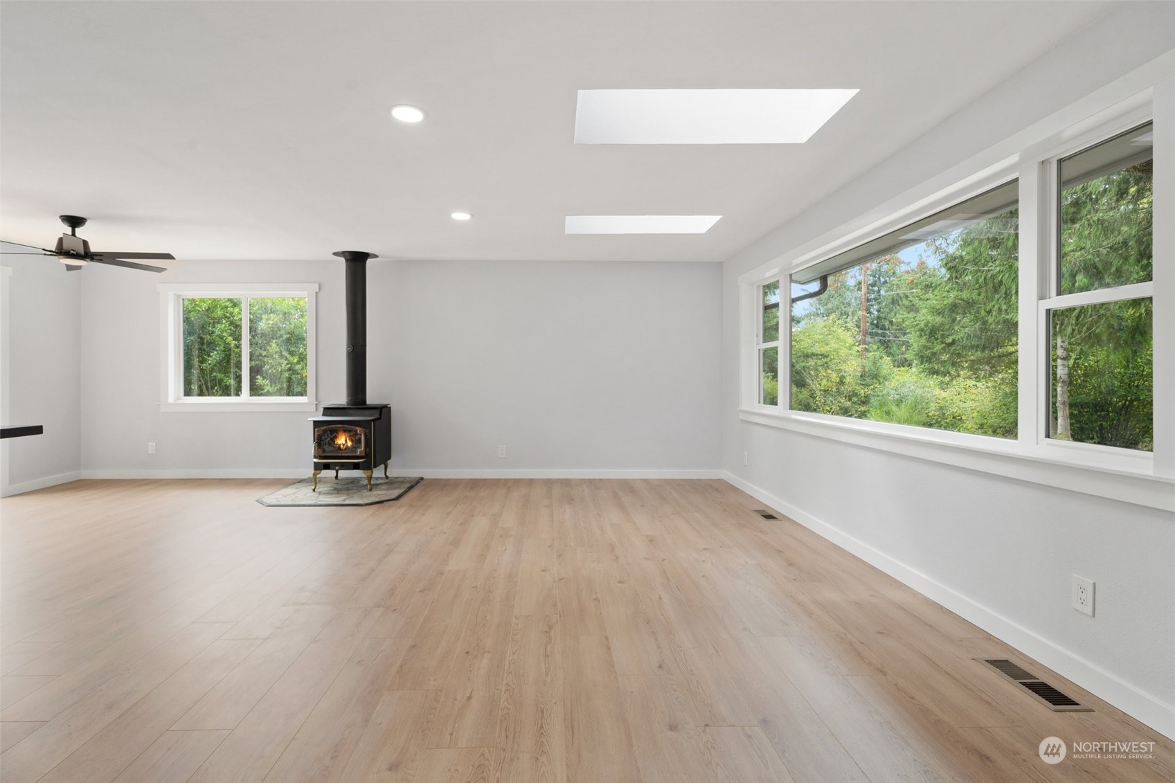 18832 196th Avenue Southeast Renton, WA 98058 - Photo 6 of 33 a view of an empty room with a window and wooden floor
