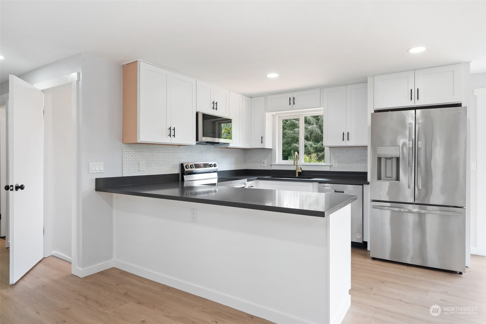 18832 196th Avenue Southeast Renton, WA 98058 - Photo 9 of 33 a kitchen with stainless steel appliances granite countertop a refrigerator sink and microwave