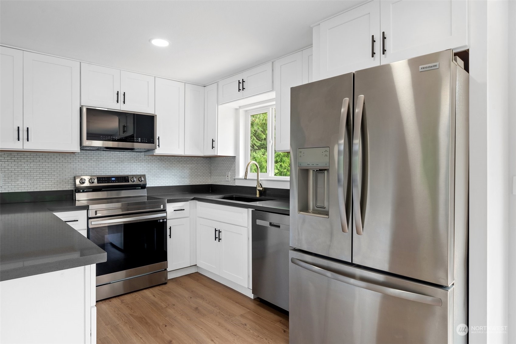 18832 196th Avenue Southeast Renton, WA 98058 - Photo 10 of 33 a kitchen with stainless steel appliances a refrigerator stove and microwave