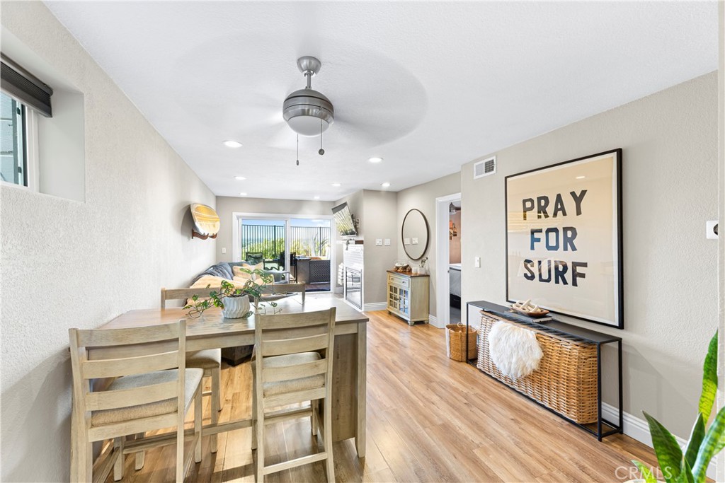 a view of a center island with furniture and wooden floor