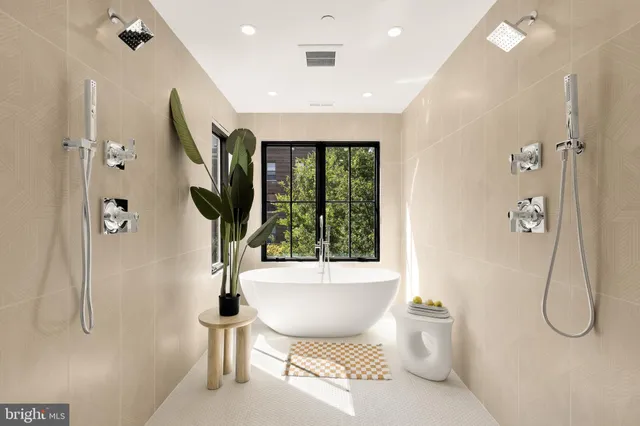 a living room with a patio furniture and a potted plant