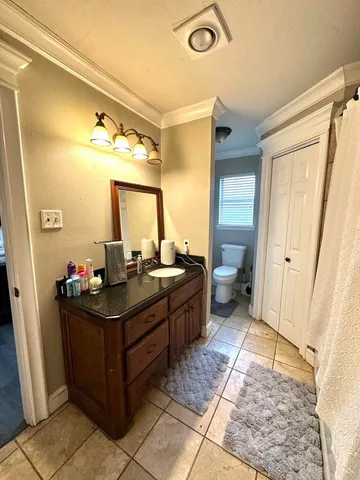 a spacious bathroom with a double vanity sink and a mirror