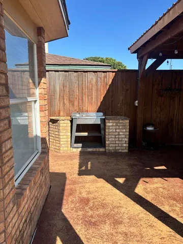 a patio with table and chairs