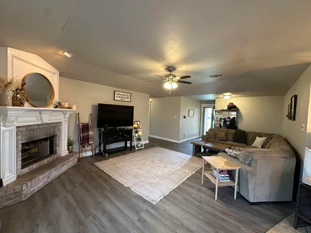 a living room with furniture and a fireplace