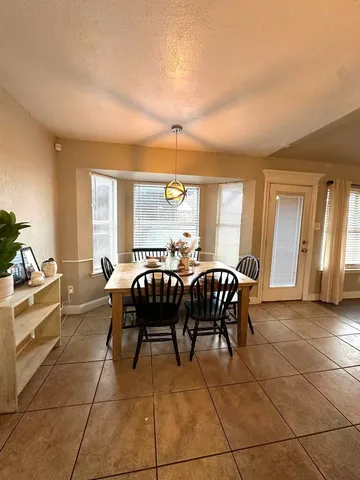 a dining room with furniture and window