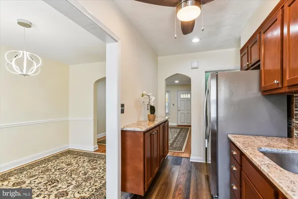 a kitchen with stainless steel appliances granite countertop a refrigerator and a stove