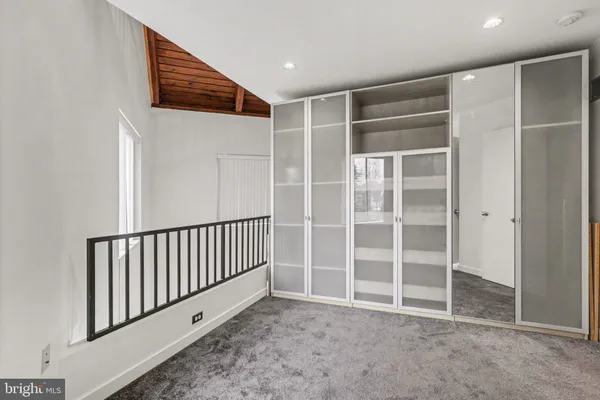 a view of an empty room with a staircase