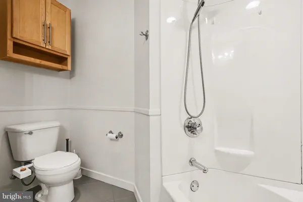 a bathroom with a shower a toilet and sink