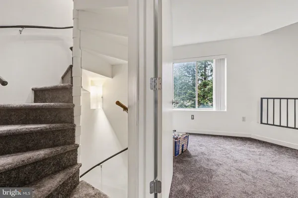 a view of a hallway with wooden floor and entryway
