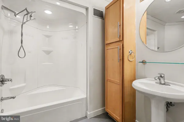 a bathroom with a sink a mirror and a bathtub