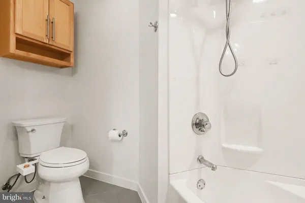 a bathroom with a granite countertop toilet sink and shower