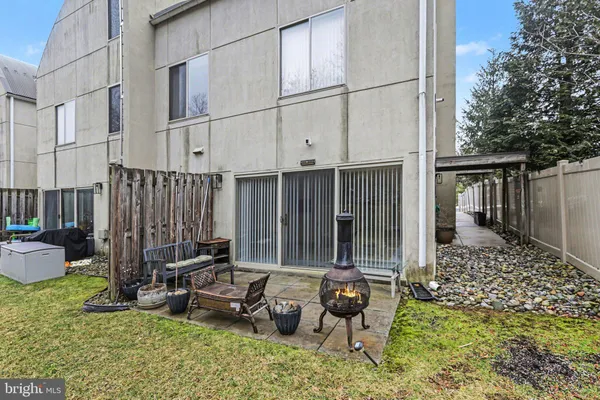 a backyard of a house with outdoor seating