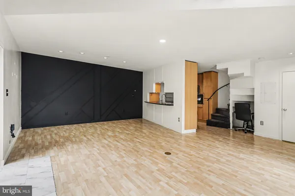 a view of empty room with wooden floor