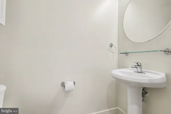 a bathroom with a sink a mirror and a toilet