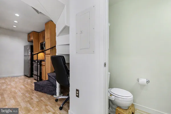 a bathroom with a toilet and a mirror