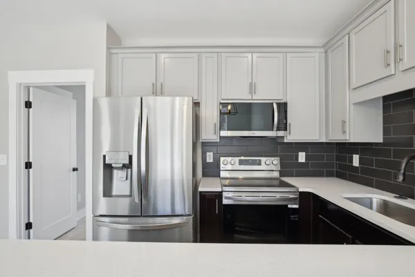 a kitchen with a refrigerator and cabinets