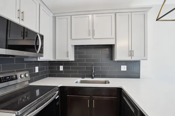 a kitchen with a sink and cabinets