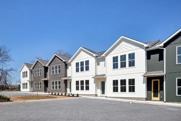 a view of a white house with a street
