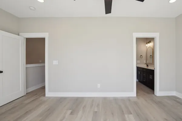 a view of an empty room with closet and a window