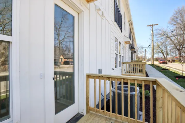 a view of a balcony with wooden floor