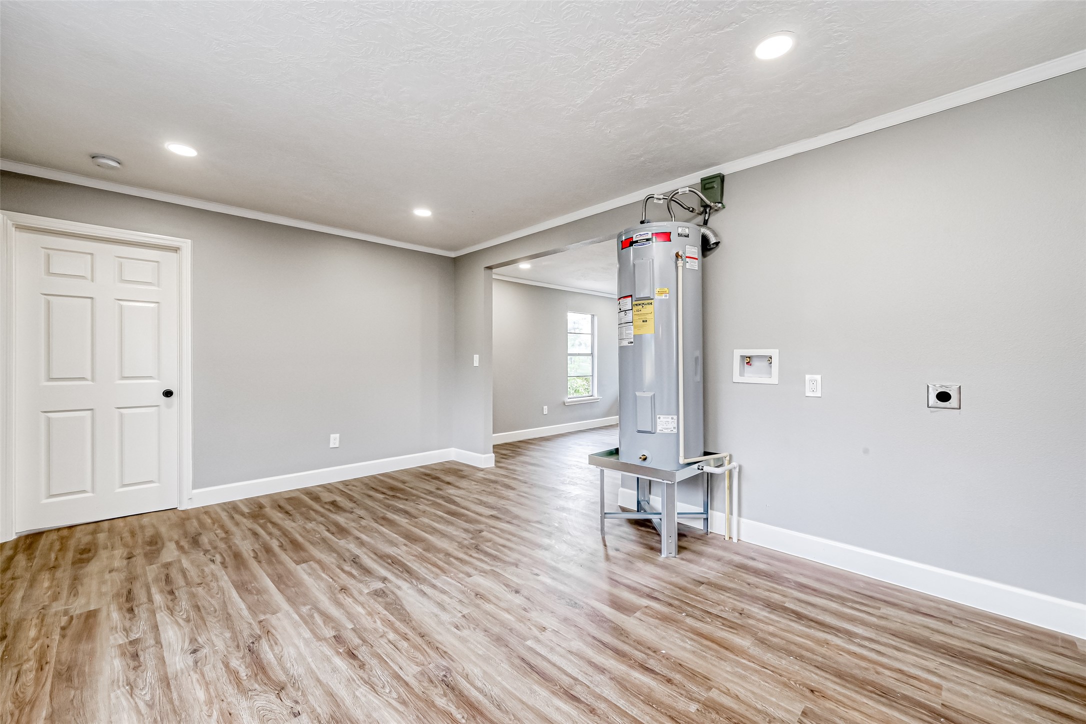 6715 Victoria Street Houston, TX 77020 - Photo 14 of 46 a view of an empty room with wooden floor and a bathroom
