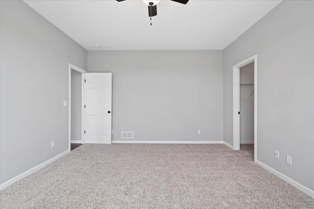 an empty room with a ceiling fan