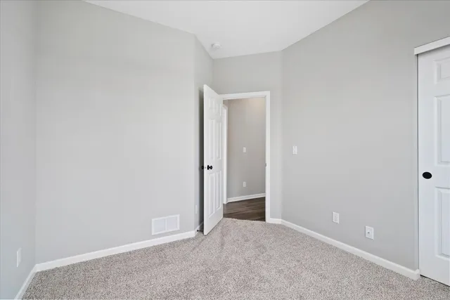 a view of an empty room and closet area