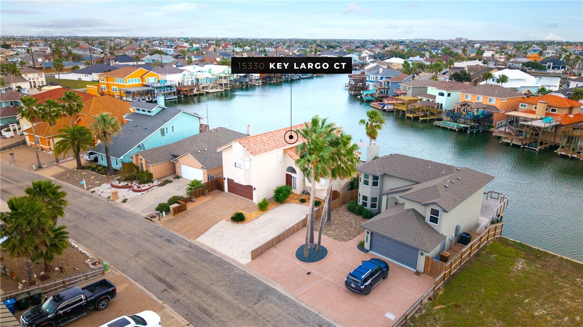 an aerial view of a house with swimming pool and ocean view