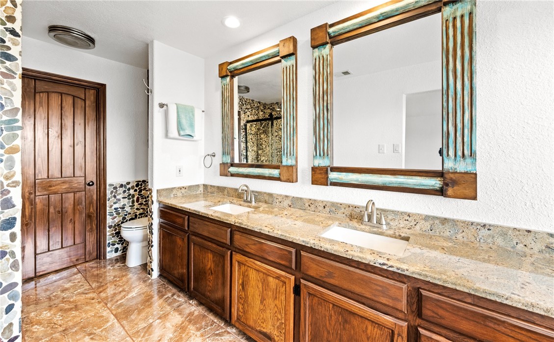 15330 Key Largo Court Corpus Christi, TX 78418 - Photo 12 of 33 a bathroom with a granite countertop sink and a mirror
