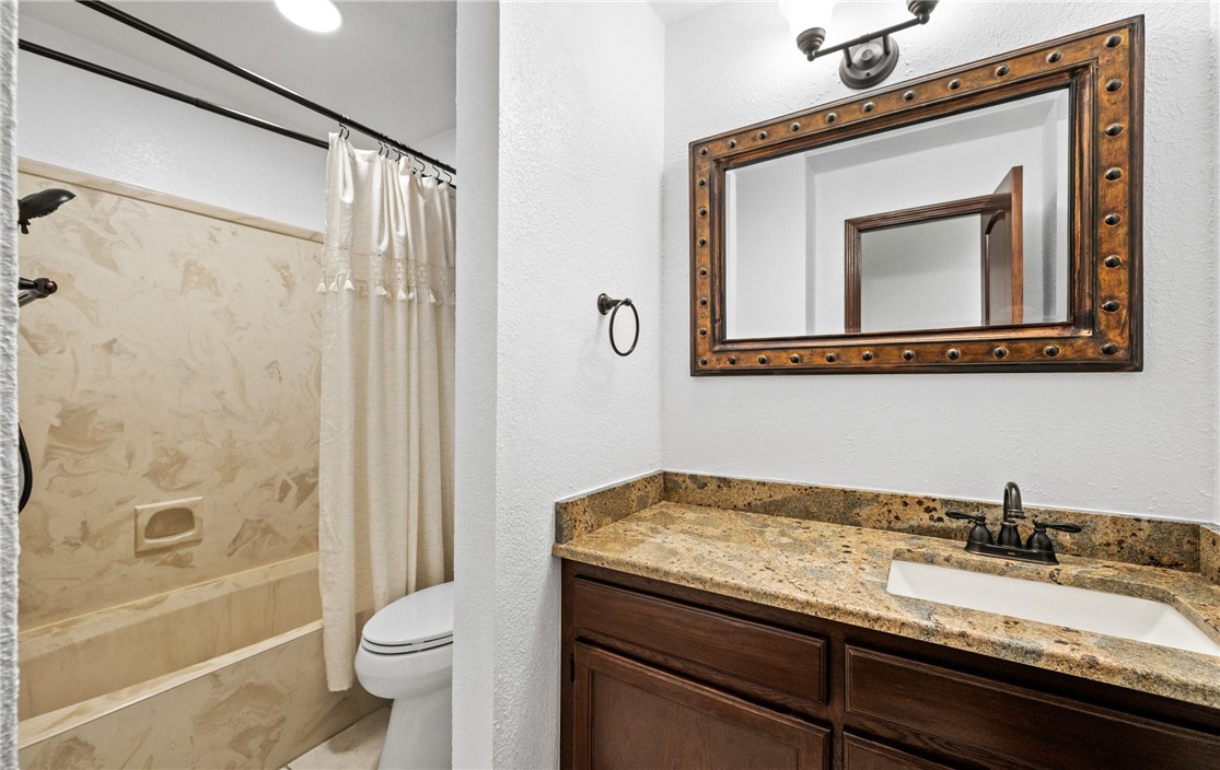 15330 Key Largo Court Corpus Christi, TX 78418 - Photo 16 of 33 a bathroom with a granite countertop sink toilet and shower