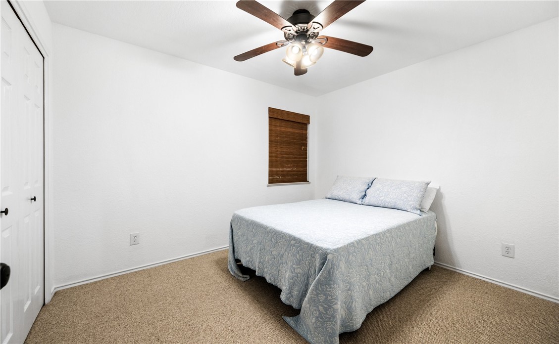 15330 Key Largo Court Corpus Christi, TX 78418 - Photo 17 of 33 a bedroom with a bed and a chandelier