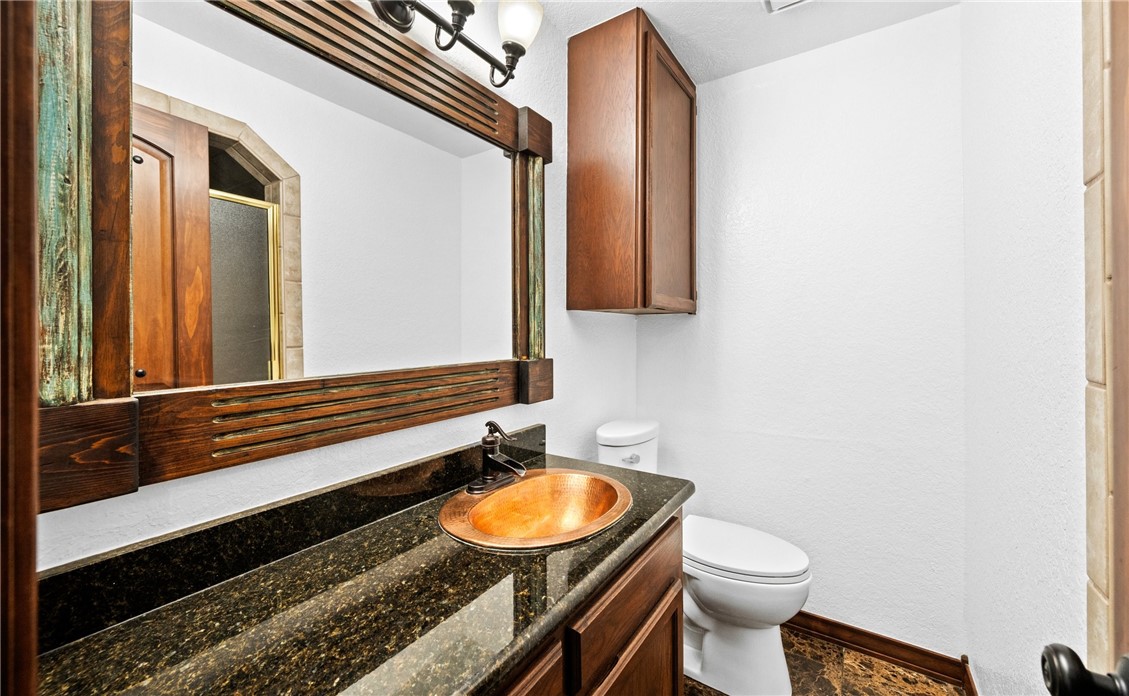 15330 Key Largo Court Corpus Christi, TX 78418 - Photo 20 of 33 a bathroom with a sink a toilet and mirror
